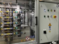 Automated multi-channel faucet durability GROHE test stand in the GROHE endurance testing laboratory with integrated control cabinet and safety indicators, developed by S.E.A. Datentechnik.