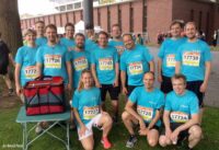 Group photo of runners in light blue shirts.